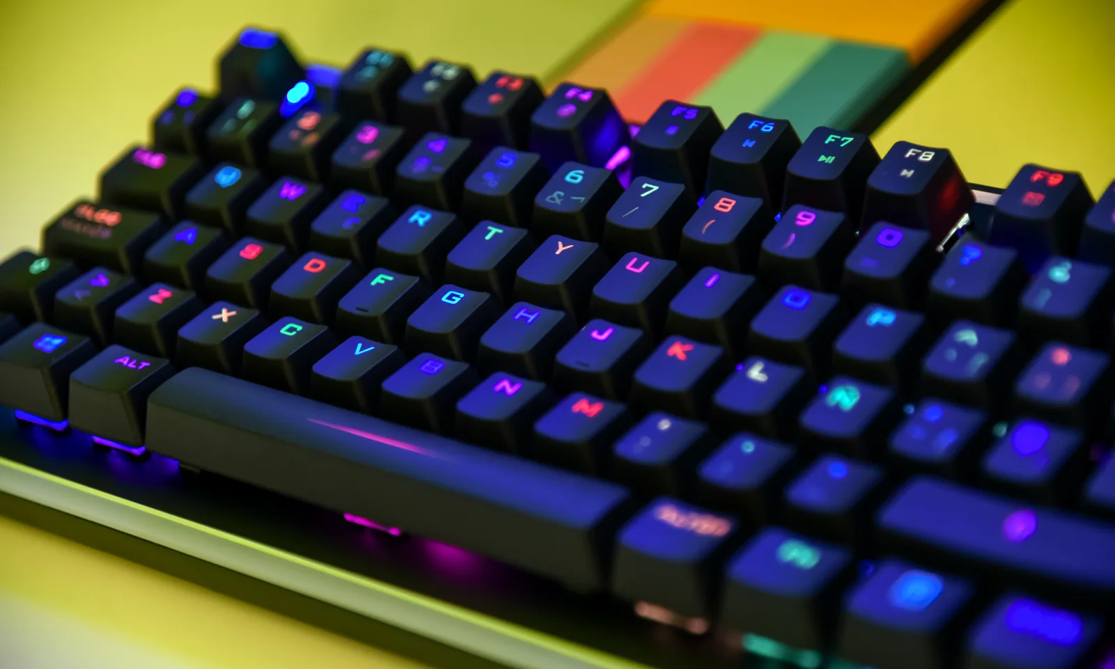 Backlit RGB mechanical gaming keyboard on a desk, ready for PC gaming