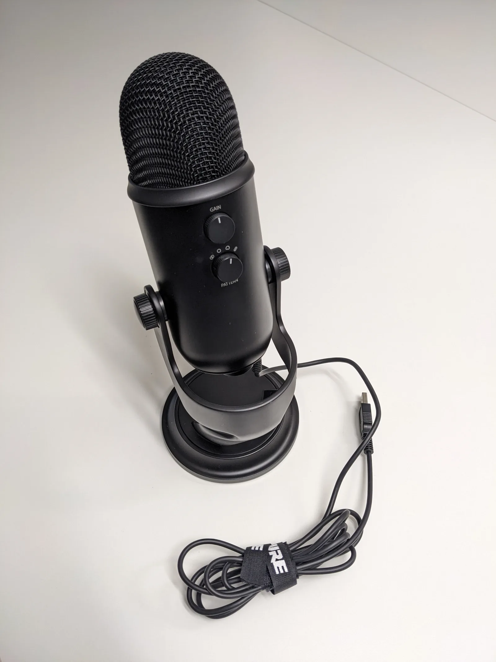 Blue Yeti Blackout USB condenser microphone on a desk, core of a streaming setup